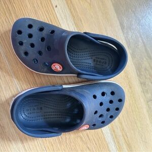 CROCS Black and Cream Sandals with Red Accents